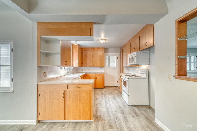 kitchen featuring light hardwood / wood-style floors, decorative backsplash, white appliances, and sink