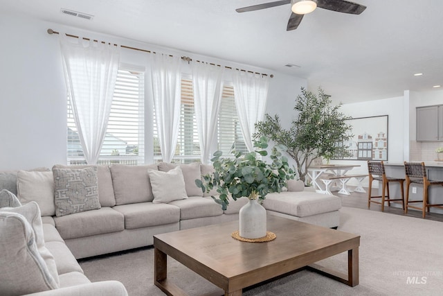 living area featuring a ceiling fan, recessed lighting, and visible vents