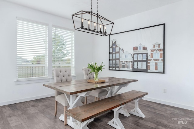dining space featuring plenty of natural light, wood finished floors, and a chandelier