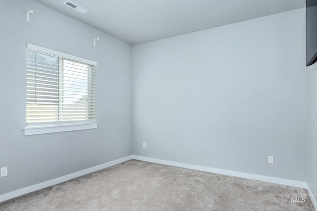 empty room with baseboards, carpet, and visible vents
