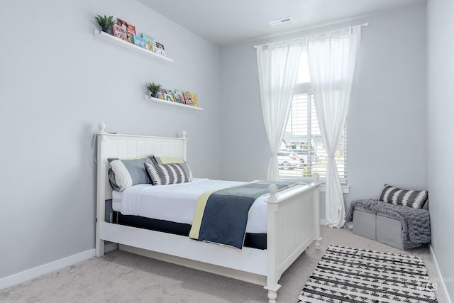 bedroom with carpet floors, baseboards, and visible vents