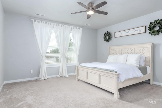bedroom featuring baseboards, light carpet, a ceiling fan, and visible vents