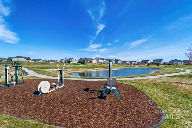 view of community featuring a residential view, a water view, and a yard