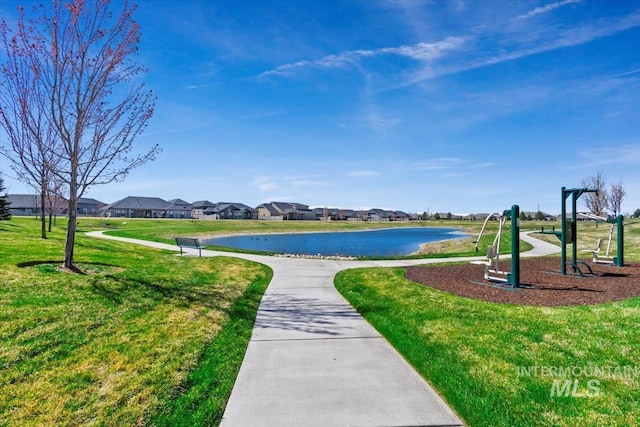 surrounding community with a lawn, a water view, and a residential view