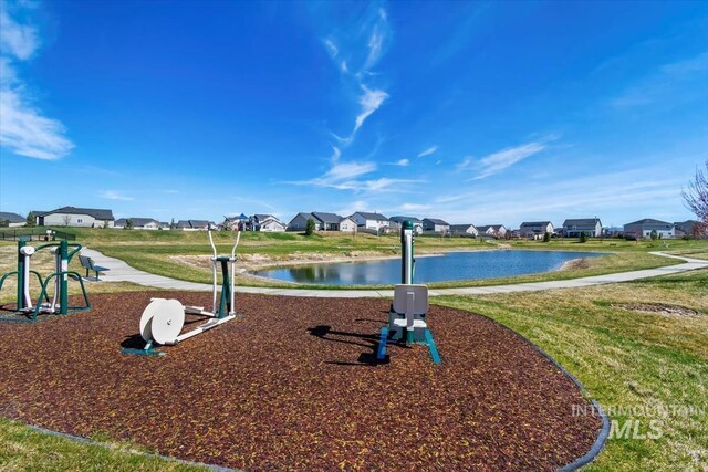 view of community featuring a residential view, a water view, and a yard