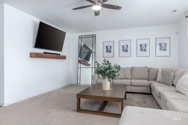 carpeted living room featuring visible vents, baseboards, and ceiling fan