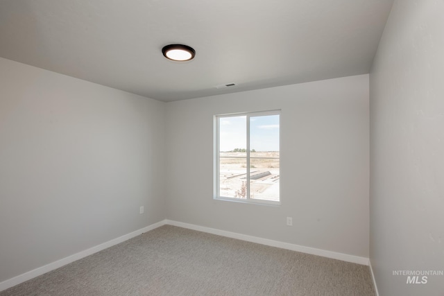 carpeted empty room with visible vents and baseboards