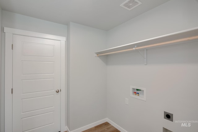 washroom with light wood finished floors, visible vents, hookup for a washing machine, electric dryer hookup, and laundry area