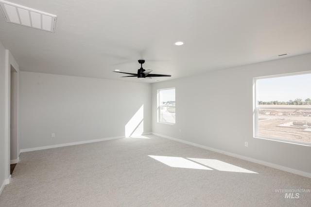 empty room featuring recessed lighting, baseboards, visible vents, and light carpet
