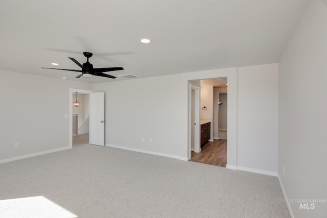 empty room featuring light carpet, visible vents, baseboards, recessed lighting, and ceiling fan