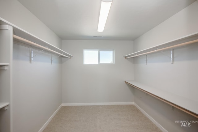 spacious closet featuring light carpet and visible vents