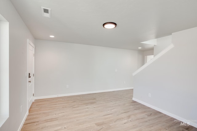 below grade area featuring recessed lighting, visible vents, light wood finished floors, and baseboards