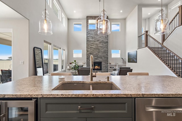 6071 S Pioneer Trail Way, Meridian, ID 83642 - kitchen featuring gray cabinets, beverage cooler, a towering ceiling, dishwasher, and open floor plan