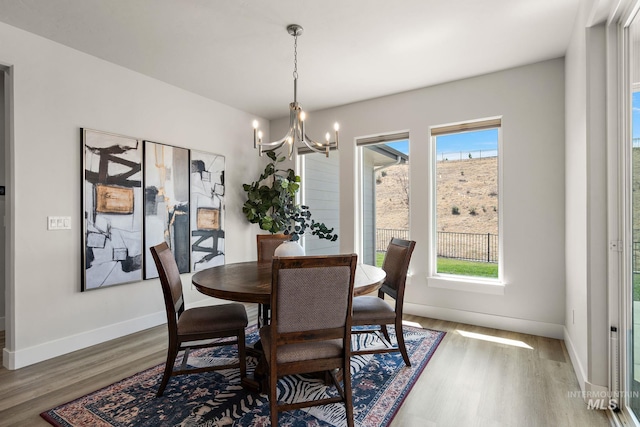 6071 S Pioneer Trail Way, Meridian, ID 83642 - dining space featuring plenty of natural light, a chandelier, and wood finished floors