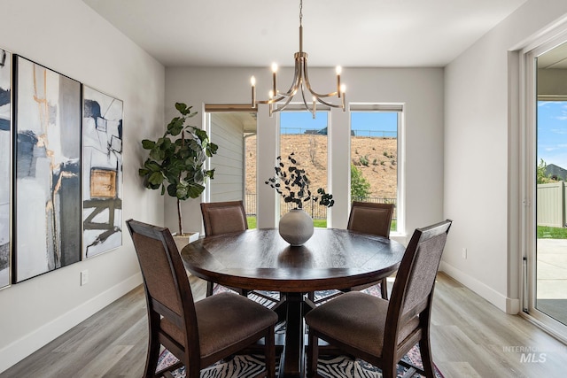 6071 S Pioneer Trail Way, Meridian, ID 83642 - dining room with light wood-style floors and a chandelier