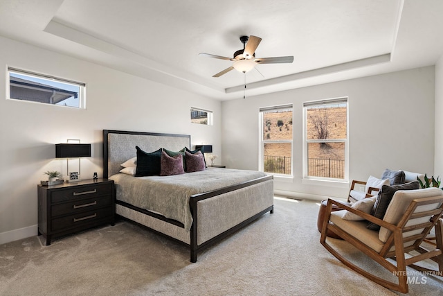 6071 S Pioneer Trail Way, Meridian, ID 83642 - bedroom featuring a tray ceiling, light colored carpet, multiple windows, and a ceiling fan