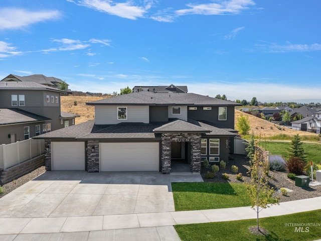 6071 S Pioneer Trail Way, Meridian, ID 83642 - prairie-style house featuring concrete driveway, a shingled roof, stone siding, an attached garage, and a residential view