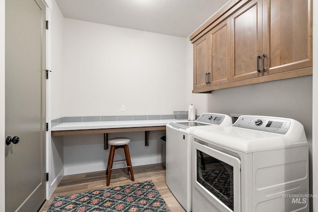 6071 S Pioneer Trail Way, Meridian, ID 83642 - laundry area with cabinet space, washing machine and clothes dryer, and light wood finished floors