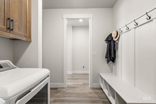 6071 S Pioneer Trail Way, Meridian, ID 83642 - washroom with washer / dryer, cabinet space, and light wood-style flooring