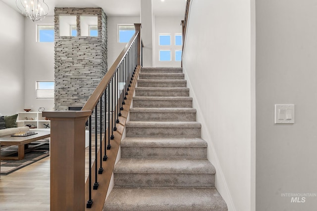 6071 S Pioneer Trail Way, Meridian, ID 83642 - stairs featuring a high ceiling, wood finished floors, and a chandelier