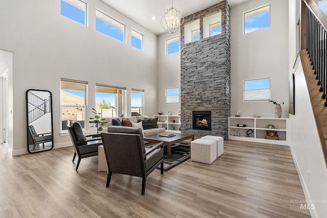 6071 S Pioneer Trail Way, Meridian, ID 83642 - living area with a towering ceiling, stairway, wood finished floors, a chandelier, and healthy amount of natural light