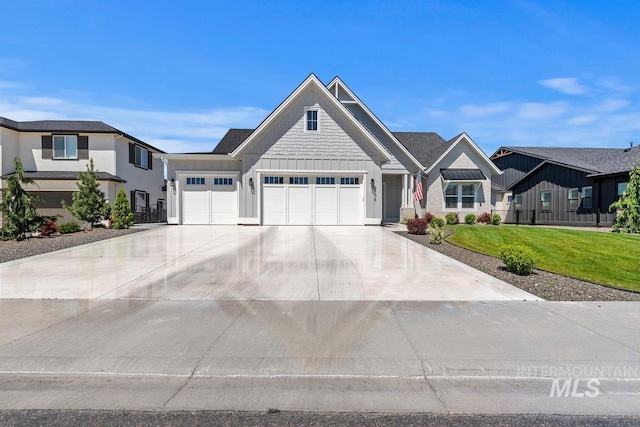 6706 Big Wood Way, Star, ID 83669 - view of front of home featuring board and batten siding, a garage, a front lawn, and concrete driveway