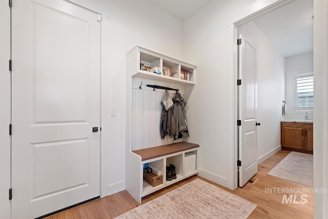 6706 Big Wood Way, Star, ID 83669 - mudroom featuring light wood finished floors, baseboards, and a sink