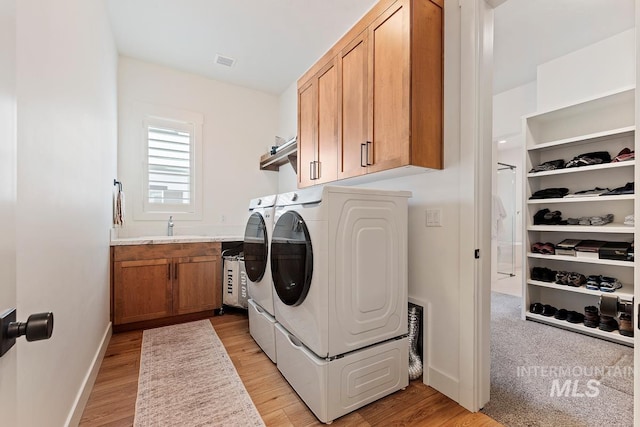 6706 Big Wood Way, Star, ID 83669 - laundry area with washing machine and clothes dryer, light wood-style floors, baseboards, and cabinet space