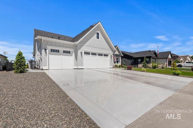 6706 Big Wood Way, Star, ID 83669 - view of front of property with board and batten siding, a garage, driveway, and a residential view
