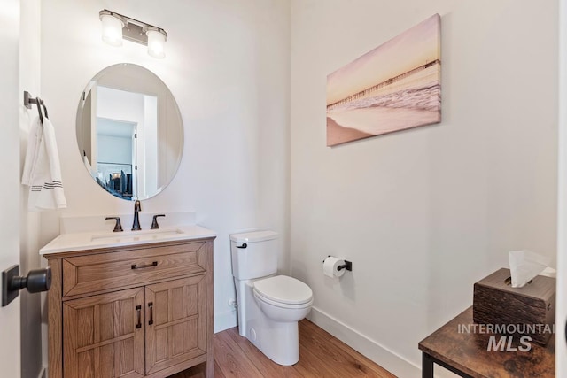 6706 Big Wood Way, Star, ID 83669 - bathroom with toilet, vanity, wood finished floors, and baseboards