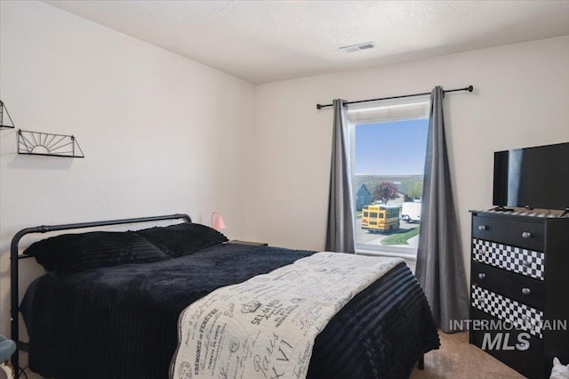 bedroom featuring carpet and visible vents