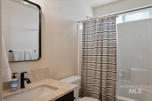 full bath featuring toilet, vanity, and shower / bathtub combination with curtain