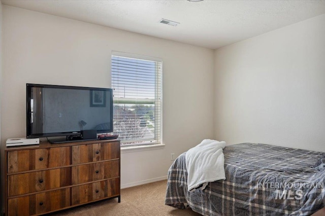 bedroom with visible vents, baseboards, and carpet