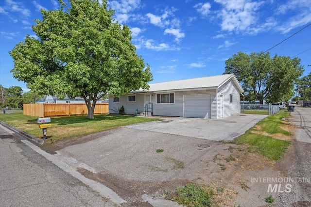 1030 18th St, Heyburn, ID 83336 - ranch-style home featuring a garage, asphalt driveway, and a metal roof