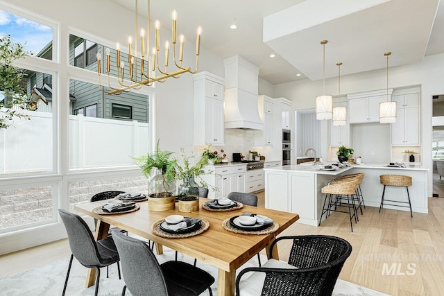 dining space with recessed lighting, light wood-style flooring, and a healthy amount of sunlight