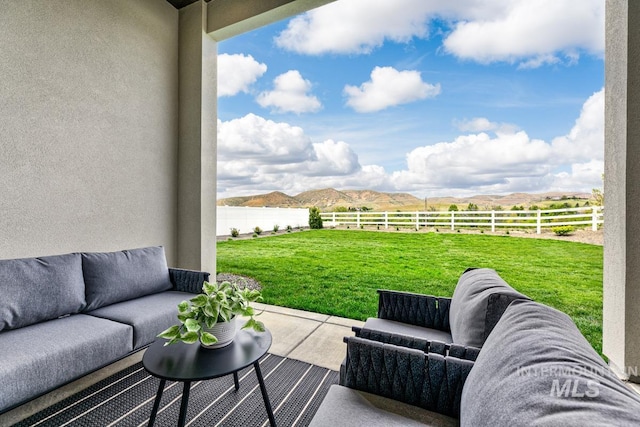 view of patio with a fenced backyard, outdoor lounge area, and a mountain view