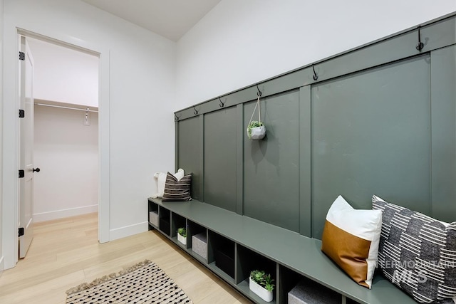 mudroom featuring baseboards and light wood finished floors