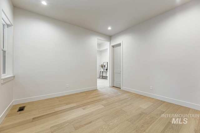 spare room featuring recessed lighting, baseboards, visible vents, and light wood finished floors