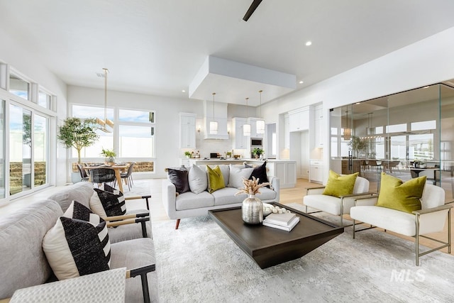 living room with recessed lighting and light wood-style flooring