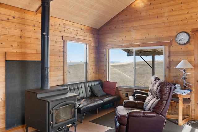 living area featuring a wood stove, wooden walls, and vaulted ceiling