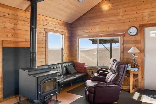 living room featuring vaulted ceiling, wood ceiling, a wood stove, and wooden walls