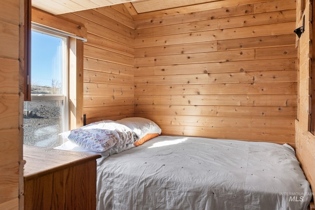 bedroom with wood walls