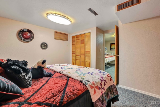 bedroom featuring a closet, carpet floors, and a textured ceiling