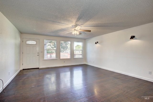 foyer featuring dark hardwood / wood-style flooring, ceiling fan, and a textured ceiling