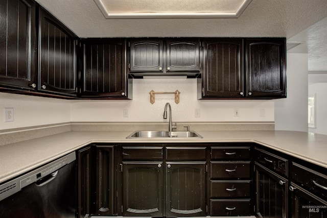 kitchen with dishwasher, a textured ceiling, and sink