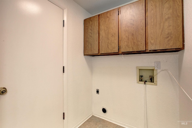 washroom with hookup for a washing machine, cabinets, hookup for an electric dryer, and light tile patterned flooring