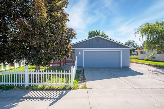 view of front facade featuring a garage and an outbuilding