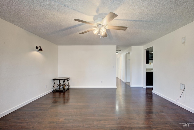 spare room with ceiling fan, dark hardwood / wood-style floors, and a textured ceiling