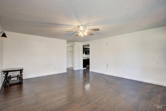 unfurnished living room featuring dark hardwood / wood-style flooring, ceiling fan, and a textured ceiling