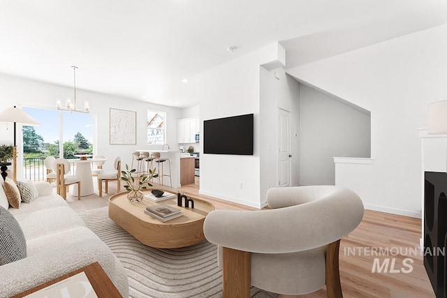 1722 N Timathy Ln Unit 32/1, Boise, ID 83713 - living room featuring plenty of natural light, light wood finished floors, a chandelier, baseboards, and recessed lighting